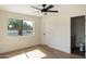 Well-lit bedroom with an ensuite bathroom and a large window overlooking the yard at 10620 N 84Th St, Scottsdale, AZ 85260
