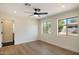 Bright bedroom with hardwood floors, a ceiling fan, and large windows at 10620 N 84Th St, Scottsdale, AZ 85260