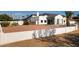 Stunning modern home with white stucco exterior and drought-tolerant landscaping at 10620 N 84Th St, Scottsdale, AZ 85260