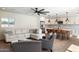 Open-concept living room showcasing modern kitchen, hardwood flooring, and plush furniture at 10620 N 84Th St, Scottsdale, AZ 85260
