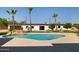 Backyard features a stunning pool, palm trees and meticulous landscaping, creating a serene outdoor oasis at 10620 N 84Th St, Scottsdale, AZ 85260