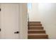 Bright staircase featuring a black handrail and wood steps at 10620 N 84Th St, Scottsdale, AZ 85260