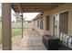 Relaxing covered patio with outdoor ceiling fan and adjacent yard at 1132 E Harbor View Dr, Gilbert, AZ 85234