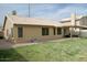 Spacious backyard featuring a covered patio and lush green grass at 1132 E Harbor View Dr, Gilbert, AZ 85234