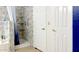 Bathroom with a tiled shower, bathtub, and dual white doors leading to other rooms at 1132 E Harbor View Dr, Gilbert, AZ 85234