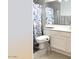 Bathroom with a toilet, vanity, mirror, floral shower curtain, and towel rack at 1132 E Harbor View Dr, Gilbert, AZ 85234