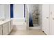 Bathroom featuring a bathtub, shower with curtain, white cabinets, and neutral colored floor tiles at 1132 E Harbor View Dr, Gilbert, AZ 85234