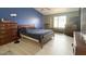 Comfortable bedroom with a large window and warm lighting, featuring a wooden bed and matching dressers at 1132 E Harbor View Dr, Gilbert, AZ 85234