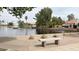 Picturesque community lake with fountain, boat dock, and inviting bench at 1132 E Harbor View Dr, Gilbert, AZ 85234