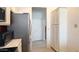 Modern kitchen with stainless steel refrigerator, microwave, and ample pantry storage space near the entryway at 1132 E Harbor View Dr, Gilbert, AZ 85234