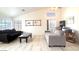 Bright living room featuring vaulted ceilings, a ceiling fan, and ample natural light from large windows at 1132 E Harbor View Dr, Gilbert, AZ 85234
