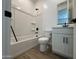 Bathroom featuring a bathtub with shower, white toilet, and vanity with framed mirror at 15786 W Cheryl Dr, Waddell, AZ 85355