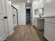 Bright bathroom featuring a glass shower, double vanities, tile floors, and a walk-in closet at 15786 W Cheryl Dr, Waddell, AZ 85355