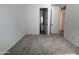 Bedroom with neutral carpet and doorway leading to ensuite bathroom at 15786 W Cheryl Dr, Waddell, AZ 85355