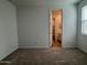 A serene bedroom with neutral carpet and a window with blinds at 15786 W Cheryl Dr, Waddell, AZ 85355