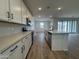 Open kitchen featuring modern appliances, white cabinetry, and an island with breakfast bar, creating a welcoming space at 15786 W Cheryl Dr, Waddell, AZ 85355