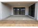 Covered patio with sliding glass doors, providing an inviting transition to the backyard space at 15786 W Cheryl Dr, Waddell, AZ 85355