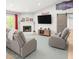 Cozy living room featuring light gray furniture, whitewashed brick fireplace, and rustic sliding door at 3736 E Decatur St, Mesa, AZ 85205