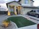 Charming two-story home with a beautifully landscaped front yard featuring grass and decorative stone at 4152 S 249Th Dr, Buckeye, AZ 85326