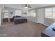 Bright bedroom with large windows, a fan, and a gray bed at 10245 N 15Th Dr, Phoenix, AZ 85021