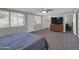Bright bedroom featuring a ceiling fan, television and closet with shelving at 10245 N 15Th Dr, Phoenix, AZ 85021