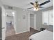 Neutral bedroom featuring carpet, fan, window, closet and adjacent hallway with wood floors at 10245 N 15Th Dr, Phoenix, AZ 85021