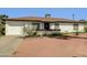 Charming single-story home with desert landscaping, window trim, and a driveway at 10245 N 15Th Dr, Phoenix, AZ 85021