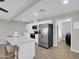 Bright open kitchen with stainless steel appliances, white cabinetry, and island with seating at 10245 N 15Th Dr, Phoenix, AZ 85021