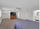 Spacious main bedroom with a large window, bathroom access, fan and lots of natural light at 10245 N 15Th Dr, Phoenix, AZ 85021