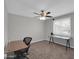 Bright office with a ceiling fan, two work desks, and large windows providing ample natural light at 10245 N 15Th Dr, Phoenix, AZ 85021