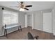 Bright office featuring a ceiling fan, a closet, two work desks, and large windows providing ample natural light at 10245 N 15Th Dr, Phoenix, AZ 85021