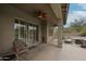 Covered patio with ceiling fan and a seating area overlooking the yard and pool at 10423 E Verbena Ln, Scottsdale, AZ 85255
