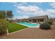 Lush backyard with a sparkling pool, manicured turf, and desert landscaping, creating a serene retreat at 10423 E Verbena Ln, Scottsdale, AZ 85255
