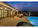 Backyard patio with outdoor seating, fire pit, swimming pool, and mountain views at twilight at 10423 E Verbena Ln, Scottsdale, AZ 85255
