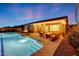 Backyard features a covered patio, swimming pool, outdoor seating area, and desert landscaping at 10423 E Verbena Ln, Scottsdale, AZ 85255