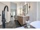 Modern bathroom featuring a standalone tub, dual vanity, and sleek fixtures with a calming color palette at 10423 E Verbena Ln, Scottsdale, AZ 85255