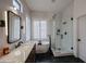 Modern bathroom featuring a standalone tub, glass shower, and sleek vanity with contemporary fixtures at 10423 E Verbena Ln, Scottsdale, AZ 85255