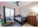 This bedroom offers a ceiling fan, window with shutters, and stylish decor at 10423 E Verbena Ln, Scottsdale, AZ 85255