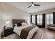 Comfortable bedroom featuring a ceiling fan, a cozy bed, and windows with natural light at 10423 E Verbena Ln, Scottsdale, AZ 85255