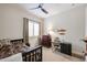 Bright bedroom with a ceiling fan, window with plantation shutters, and charming decor at 10423 E Verbena Ln, Scottsdale, AZ 85255