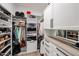 Organized walk-in closet with custom shelving, cabinets, and drawers offering ample storage space at 10423 E Verbena Ln, Scottsdale, AZ 85255