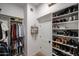 Well-organized walk-in closet with custom shelving, shoe racks, and ample hanging space at 10423 E Verbena Ln, Scottsdale, AZ 85255