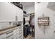 Spacious walk-in closet with custom shelving, drawers, and a jewelry rack for organized storage at 10423 E Verbena Ln, Scottsdale, AZ 85255