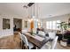 This dining room features an elegant chandelier, a large dining table, and an open-concept living space at 10423 E Verbena Ln, Scottsdale, AZ 85255