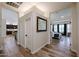 Welcoming foyer with wood flooring, offering views of the kitchen and bedroom at 10423 E Verbena Ln, Scottsdale, AZ 85255