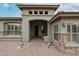 Welcoming single-story home featuring a covered entrance, desert landscaping and an open archway at 10423 E Verbena Ln, Scottsdale, AZ 85255