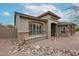 Inviting single-story home with a covered entrance, desert landscaping, and beautiful stone accents at 10423 E Verbena Ln, Scottsdale, AZ 85255