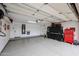 Spacious garage with epoxy flooring, water heater, and ample storage cabinets at 10423 E Verbena Ln, Scottsdale, AZ 85255
