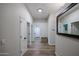 Neutral hallway featuring wood-look tile flooring, white trim, and access to multiple rooms at 10423 E Verbena Ln, Scottsdale, AZ 85255