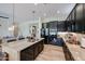 Well-designed kitchen features dark cabinets, stainless steel appliances, a granite island, and a seamless open layout at 10423 E Verbena Ln, Scottsdale, AZ 85255